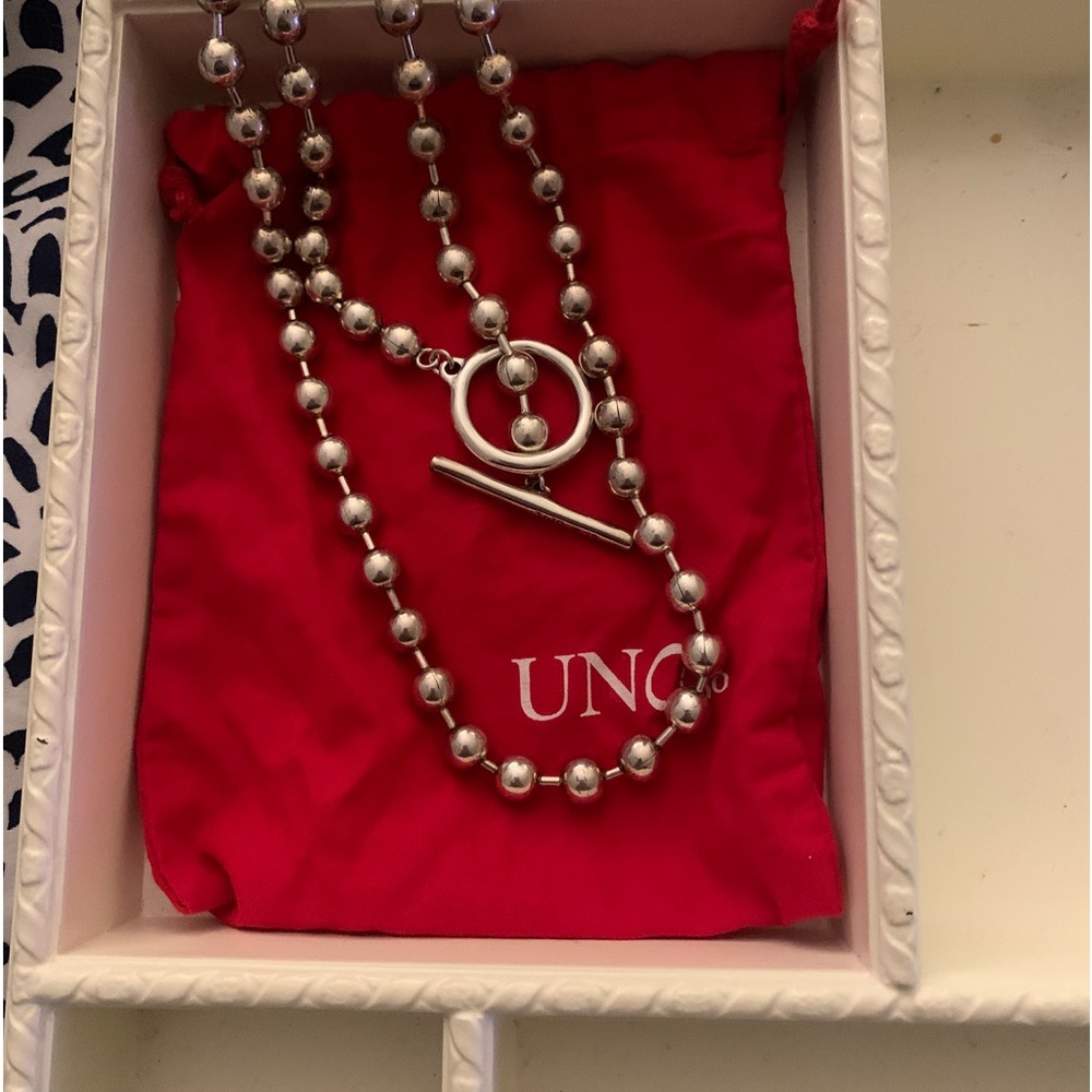 In original uno bag, never worn. Versatile lengths sterling.